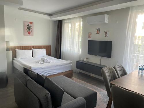 a hotel room with a bed and a tv at Sorta Hotel in Antalya