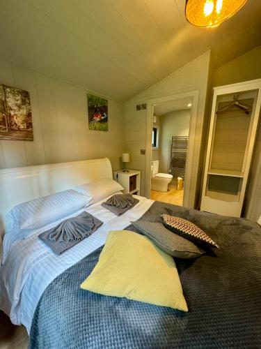 a bedroom with a large bed with two pillows on it at Riverside Cabins in Shrewsbury