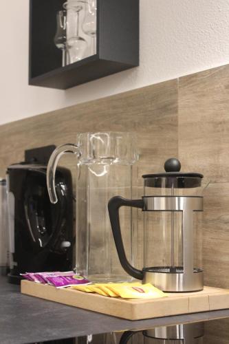 a kitchen counter with a coffee maker and affeepot at La Moretta Suite rustic apartment in Negrar