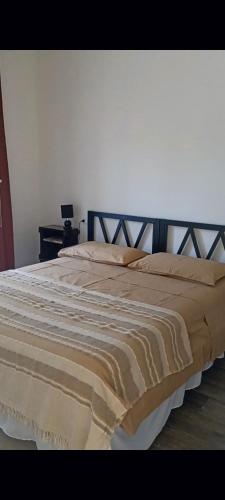 a bedroom with a large bed with a wooden headboard at Ripe's FoRest Garden Guest House in Rome