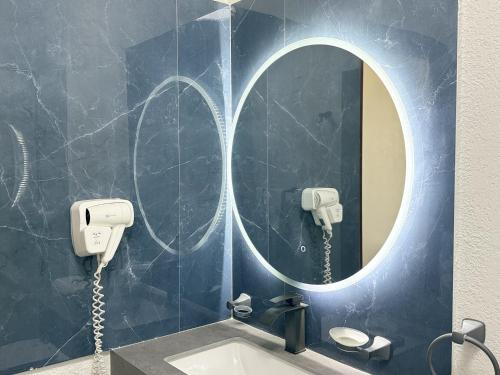 a bathroom with a mirror and a sink at Summer Luna in Dhiffushi