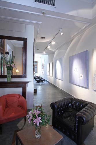 a living room with a leather couch and a table at A Hotel in Buenos Aires