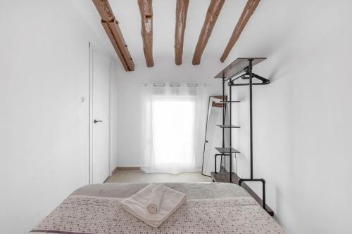 a bedroom with a bed and a window at Alcoy Old Town - Reformed Penthouse with AC and wifi in Alcoy