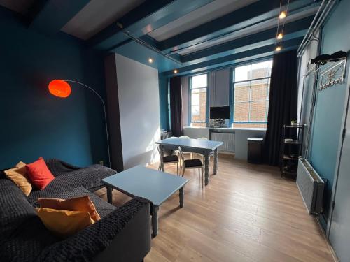 a living room with a couch and tables at Nes B&B in Amsterdam