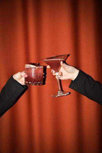a person holding a drink in a martini glass at Quality Hotel The Mill in Malmö