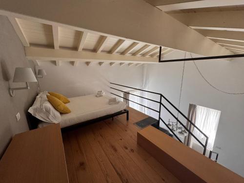 a living room with a bed and a staircase at Talè Restaurant & Suite in Piedimonte Etneo