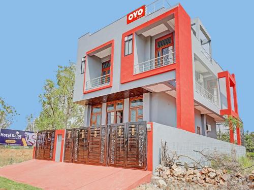 a building with an sign on top of it at Hotel O Kalot in Jaipur