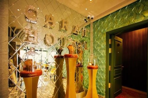 a room with two vases and chandeliers on the wall at Carat Hotel Yerevan in Yerevan