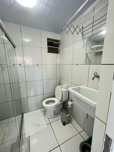 a white bathroom with a toilet and a sink at Recife - Boa Vista in Recife