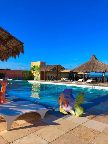 a child is playing in the water in a swimming pool at Hotel das Falésias Praia das Fontes in Beberibe