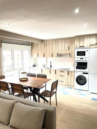 a kitchen with a table and chairs in a room at Soleado 2 in Gijón