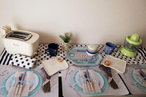 a table with a toaster and plates on it at Casa House Villa Chiara in Pula