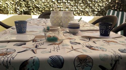 a table with a patterned table cloth on it at Casa House Villa Chiara in Pula