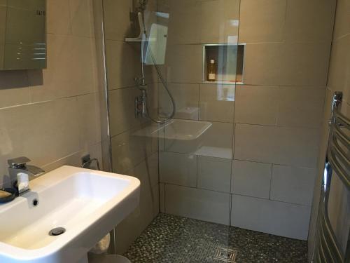 a bathroom with a sink and a shower at Garden Room in Derby