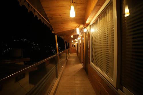 a hallway of a house at night with lights at Aman The Lake Side Nainital in Nainital