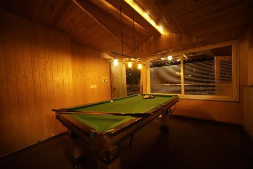 a billiard room with a pool table in it at Aman The Lake Side Nainital in Nainital
