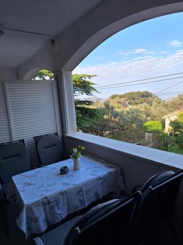 a table and chairs on a balcony with a view at House Olive Garden Strunjan in Strunjan