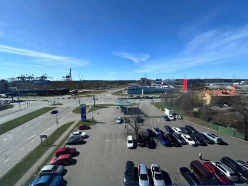 a parking lot with a bunch of parked cars at Green Park Hotel Klaipeda in Klaipėda