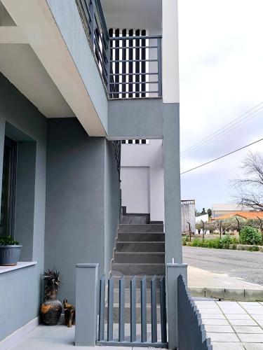 a house with a staircase and a stair railing at George Apartments in Larnaca