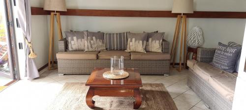 a living room with a couch and a coffee table at Le Morne View Duplex in Rivière Noire