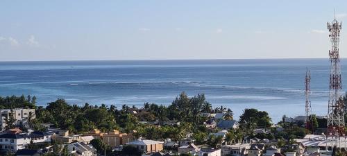 an aerial view of a city and the ocean at Le Morne View Duplex in Rivière Noire