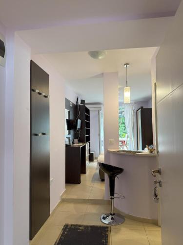 a kitchen with a counter and a stool in a room at Splendid Luxury Apartments in Budva