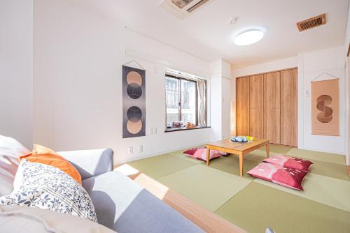 a living room with a couch and a table at Akabanestay A 志茂 in Tokyo