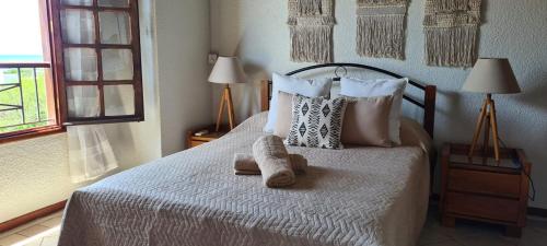 a bedroom with a bed with a teddy bear on it at Le Morne View Duplex in Rivière Noire