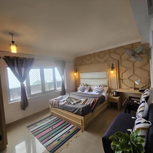 a bedroom with a bed and a large window at The Bunkk Inn Hotel & Restaurant - Mussoorie International in Mussoorie