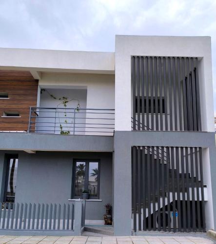 a large white house with a balcony on it at George Apartments in Larnaca