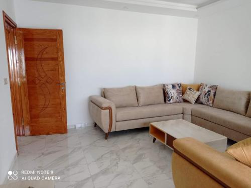 a living room with a couch and a coffee table at Dar hana in Rafrāf