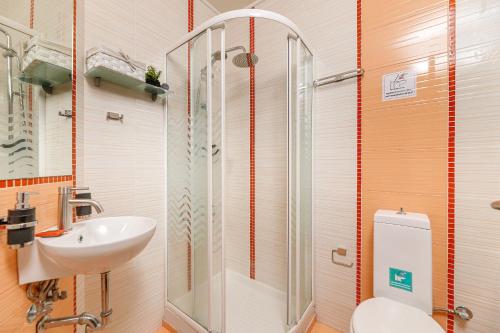 a bathroom with a shower and a sink and a toilet at Lucia's Home in Stalos