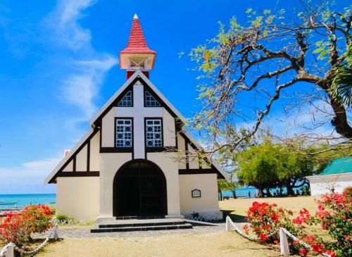 a small church on the beach with flowers at Salty Château in Cap Malheureux
