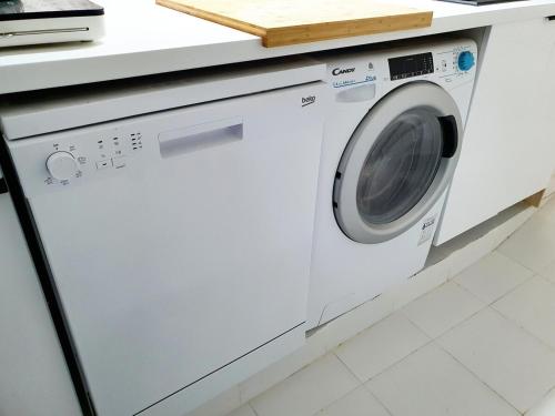 a white washing machine sitting in a kitchen at casa cueva a 15 minutos del centro de Valencia in Paterna