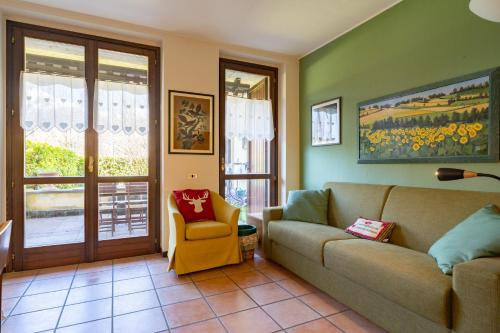 a living room with a couch and a chair at Il Giardino di Prada in Barzio