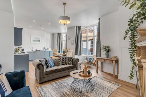 a living room with a couch and a table at 1 - Modern & Stylish 3-Bed Apartment in Cromer in Cromer