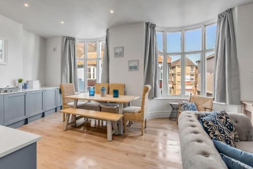 a living room with a table and a couch at 1 - Modern & Stylish 3-Bed Apartment in Cromer in Cromer