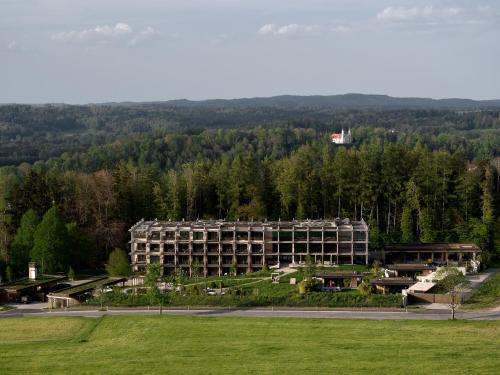 a large building in the middle of a field at Hotel BERGEBLICK in Bad Tölz