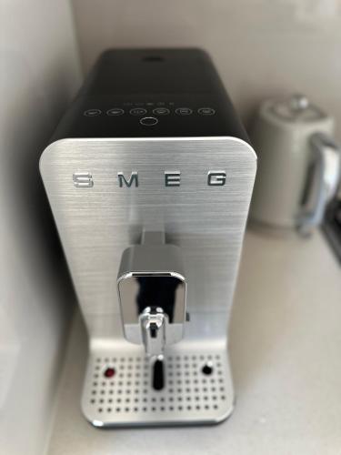 a silver and black mixer sitting on top of a counter at 89B - Your Dream Stay Business or Travel Mornings with coffee in Bentleigh in Heatherton