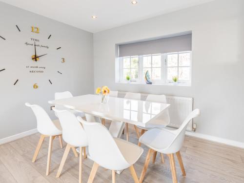 a white dining room with a white table and white chairs at Pass the Keys 4-Bedroom Seafront House in Southend Sea Views in Southend-on-Sea