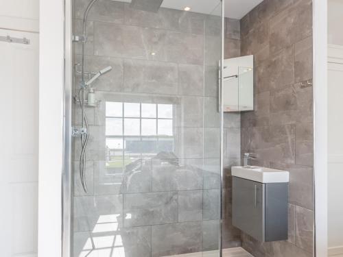 a bathroom with a shower and a toilet and a sink at Pass the Keys 4-Bedroom Seafront House in Southend Sea Views in Southend-on-Sea