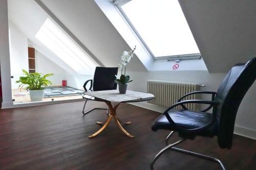 a room with a table and two chairs and a window at Quadrate Hostel Mannheim Z6 Denkmalschutz in Mannheim