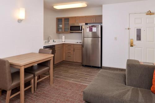 a kitchen with a table and a refrigerator at Residence Inn Palo Alto Los Altos in Palo Alto