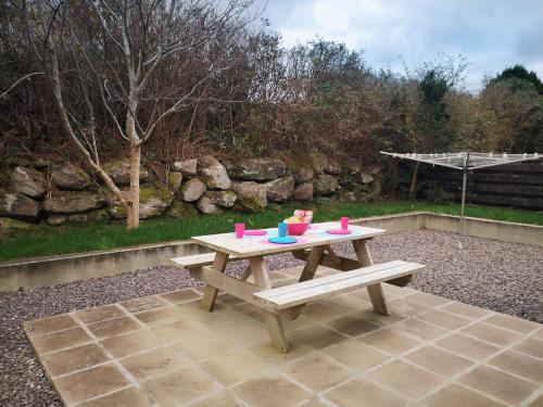 a picnic table with cups on top of it at 4 bedroomed house in Waterville close to the beach in Waterville