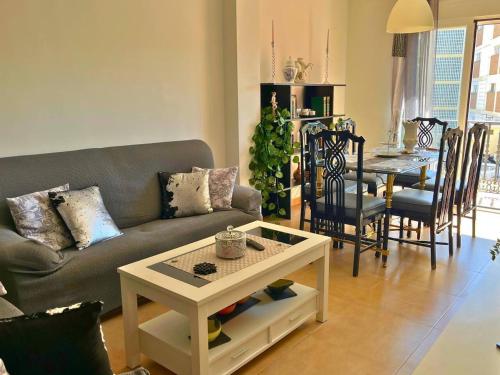 a living room with a couch and a table at Home4u Calle Barcelona in Armilla
