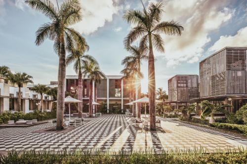 a rendering of a courtyard with palm trees at Long Beach Mauritius in Belle Mare