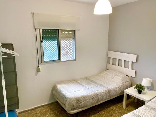 une chambre avec deux lits et une fenêtre dans l'établissement Apartamentos turísticos en Jerez de la frontera, à Jerez de la Frontera