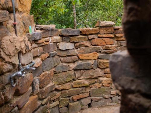 an old stone wall with a stone fence at Riverbed Africa in Lydenburg