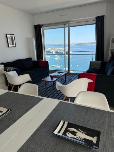 a living room with a view of the water at Appartement Design VIII - Port Rosmeur - Sublime vue Mer in Douarnenez