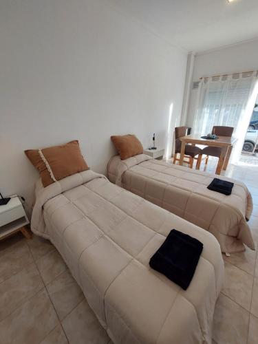 a living room with two beds and a couch at Dto funcional MT in Bahía Blanca